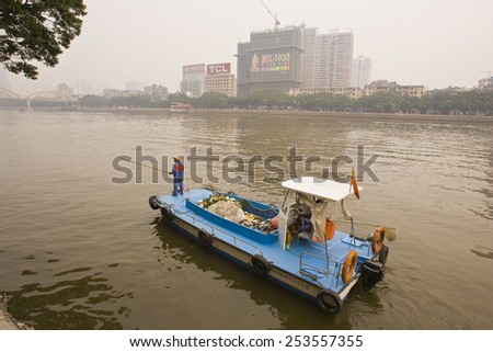 GUANGZHOU, GUANGDONG PROVINCE, CHINA - OCTOBER 12, 2006: Trash collection boat on river, in the city of Guangzhou.