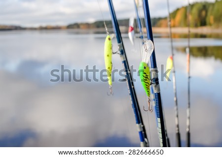 Fishing tackle for fishing rod on lake background