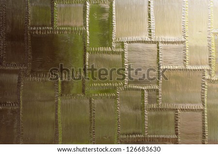 Textured glass panel with strong highlights and deep shadows
