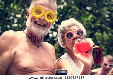 Similar – Image, Stock Photo Mature couple swimming together in fresh water