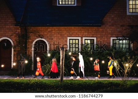Group of kids with Halloween costumes walking to trick or treating ストックフォト © 