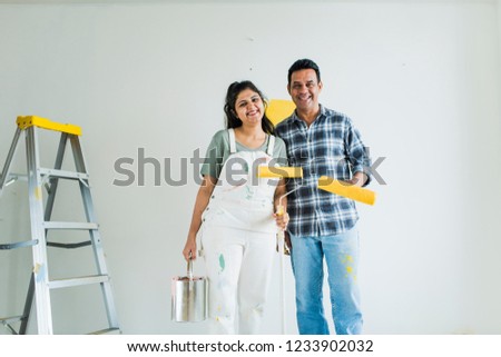 Similar – Image, Stock Photo Cheerful woman preparing paint during renovation