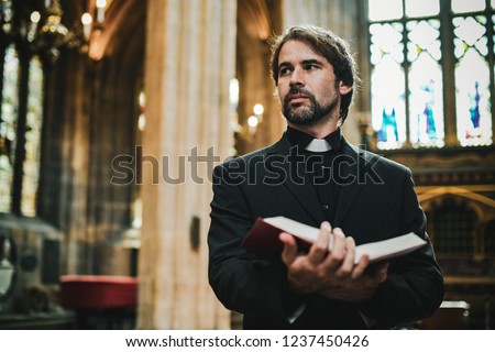 Similar – Image, Stock Photo Pastor at the altar table with the book of baptism