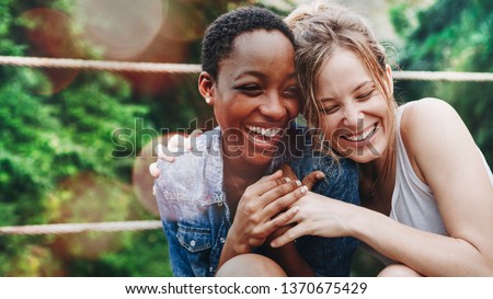Cheerful girls embracing each other