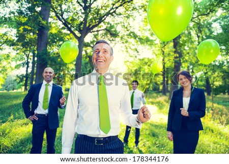 Environmentalist Business People Holding Green Balloons in Nature