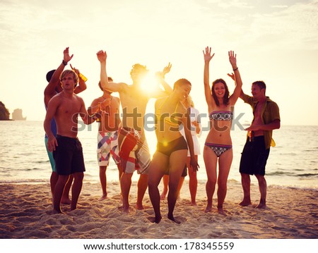 Group of People Partying on Beach at Sunset
