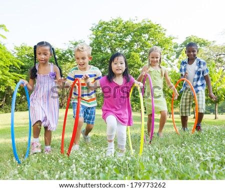 Diverse Children Playing With Hula Hoops in the Park