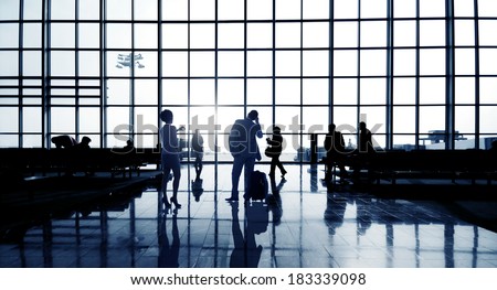 Silhouettes Of Multi-Ethnic Group Of Business People Waiting In Airport Terminal