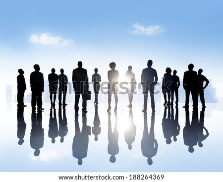 Silhouettes Of Business People Standing Outdoors In A Tranquil Urban Scene.