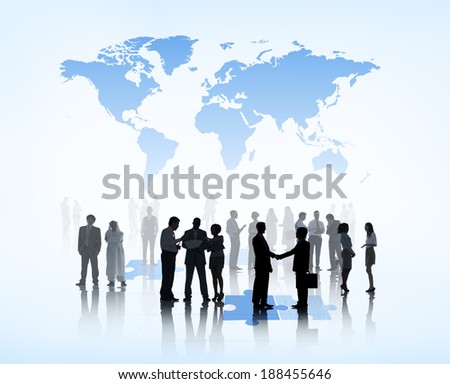 Silhouettes of Business People on Jigsaw Puzzle and World Above