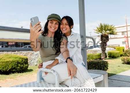 Similar – Image, Stock Photo Cheerful gay couple taking selfie on smartphone