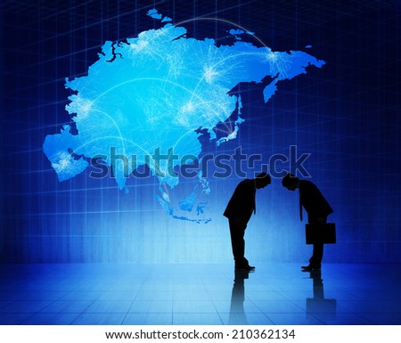 Two silhouettes of businessmen with blue cartography of Asia as a background.