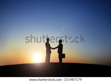 Two Businessmen Shaking Hand in Back Lit