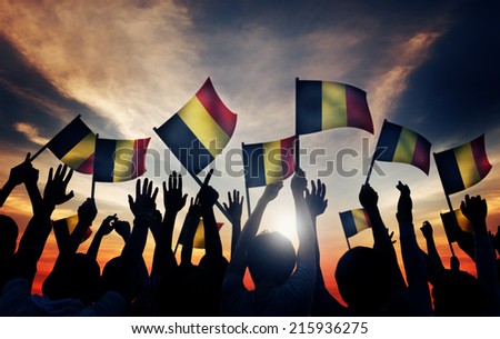 Group of People Waving Belgian Flags in Back Lit
