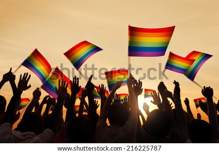 Silhouettes of People Holding Gay Pride Symbol FLag Сток-фото © 