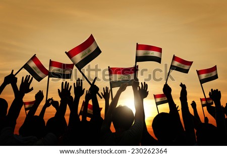 Silhouettes of People Waving the Flag of Iraq