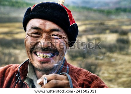 Mongolian man smoking.