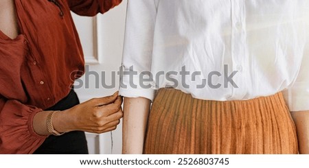 Similar – Image, Stock Photo Female tailor fitting skirt of dress