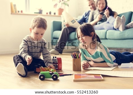 Similar – Foto Bild Zeit in Familienqualität. Vater und Tochter sitzen in einem selbstgebauten rosa Zelt mit Blumen, lesen ein großes Buch, sehen sich an, lächeln und lachen. Gemütliches stilvolles Zimmer. Konzept für Familienbande