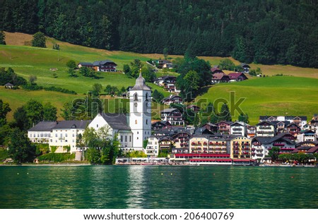 View of St. Wolfgang village waterfront at Wolfgangsee lake with beach toys in front, Austria
