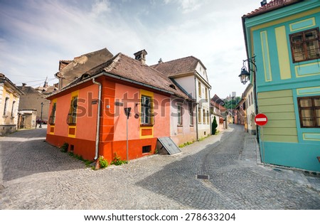 Sighisoara, Romania - June 23, 2013: Stone paved old streets with colored houses from Sighisoara fortresss, Transylvania, Romania