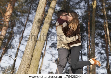 Winter fun couple outside in snow forest