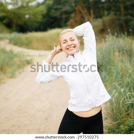 Athletic woman jogging in the evening. Training outdoors in sportswear. Concern about the health and figure.