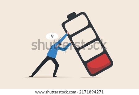 Recharge energy yourself. Fight burnout at work. Intolerance to burnout syndrome. Employees tried to prevent a large battery from falling over it.