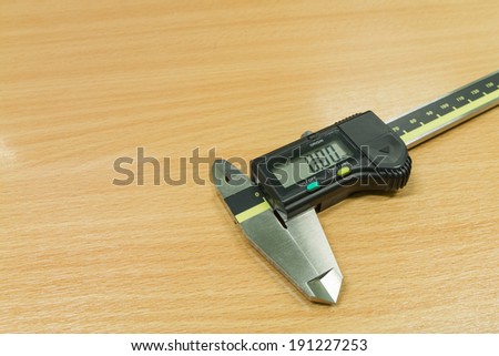 Vernier caliper on wooden table background,measurement tool