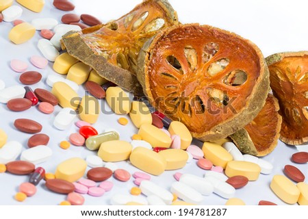 Dry Bael with medicine isolated on white background