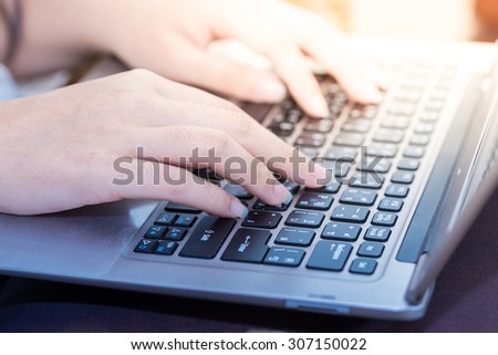 Women hands typing on laptop keyboard