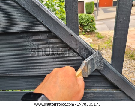 Brushing garden fence with brush - close-up Stockfoto © 