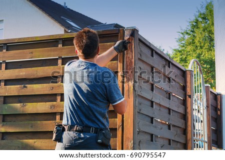 Similar – Image, Stock Photo Glaze. Woodwork, painting wood. Hand of the craftsman painting a wooden door. Concept of renovation work, carpentry and woodwork. painter, painting wooden surface, wood preservation