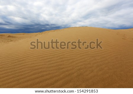 Scene in sand desert before thunderstorm