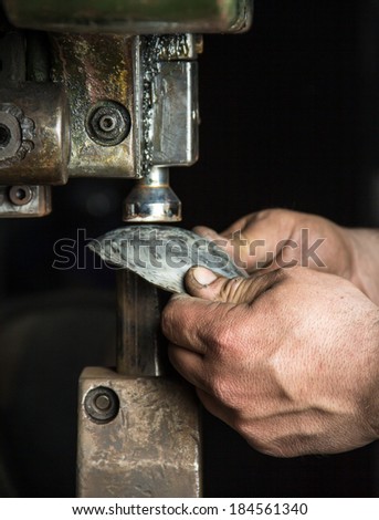 Man hands closeup working with a metal pressing machine 2