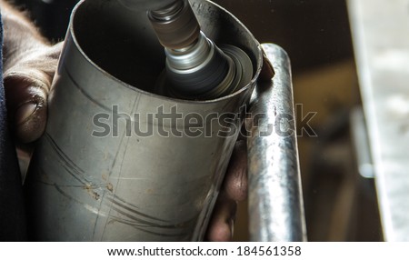 Grinding the inside of a metal cylinder