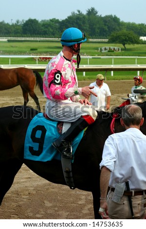 BOSTON, MA - JULY 6: A jockey points to a winning horse at Suffolk Downs July 6, 2008 in East Boston, MA.