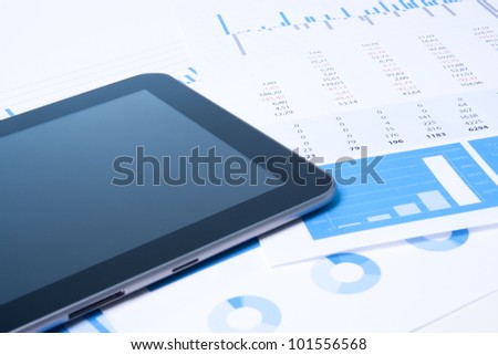 Modern business analysis with digital tablet computer, sheet and graphs.