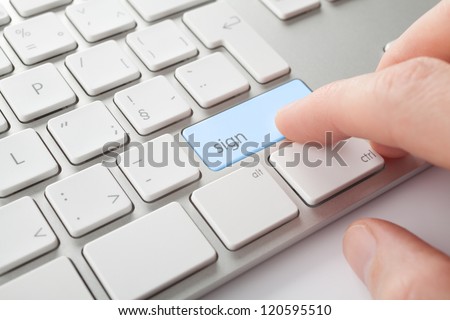 Electronic signature concept. Man press sign key on computer keyboard.