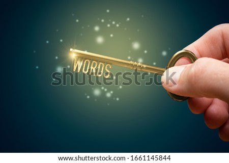 Keywords are a key for successful SEO concept. Unlock potential of your web with optimized keywords. Hand with key with text keywords. Stock foto © 