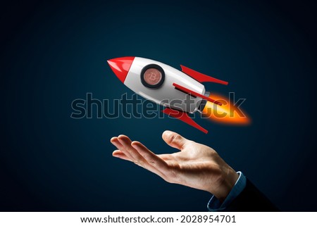 Bitcoin cryptocurrency rocket growth concept. Model of cartoon rocket representing fast growth and bitcoin coin instead of peephole.