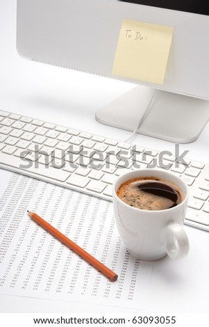 Office workplace with coffee, pencil, sheet with numbers, keyboard and blank To do list on computer