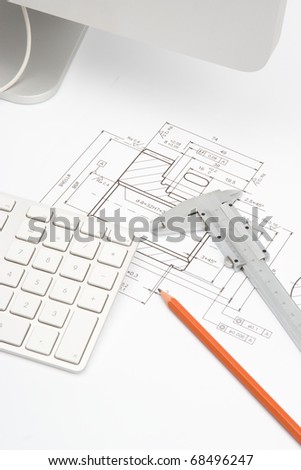 Mechanical engineer workplace - blueprint of gearwheel, caliper, pencil and part of computer