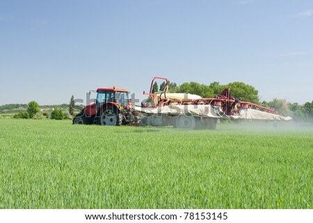 Agriculture - tractor dusting chemical manure (plant protection with pesticides)