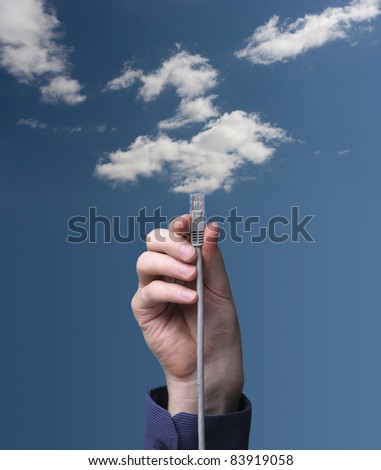 Cloud computing concept. Hand with ethernet cable connecting into cloud.