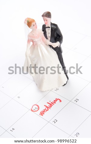 Word wedding in calendar and wedding figurines - planning a wedding concept