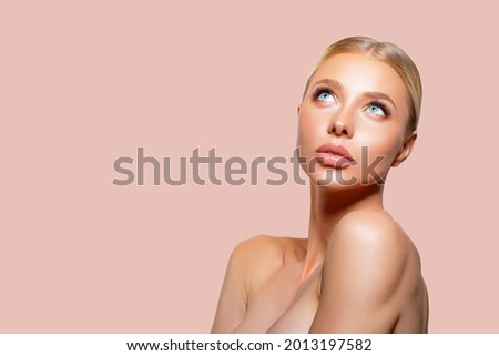 Beauty woman clean healthy skin natural make up. peach background. thick eyelashes. beauty. isolated. Fashion Beauty Portrait model looks up. spa concept. makeup. smooth hair blonde.      Foto stock © 
