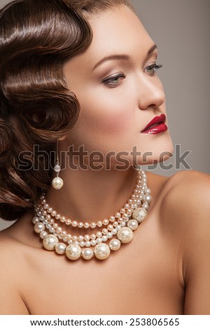 Elegant fashionable woman with jewelry .  Beautiful portrait of a model, light make-up, cherry lips