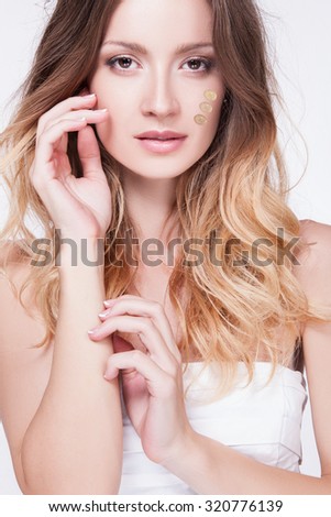 Make-up & cosmetics. Closeup portrait of beautiful woman model face with skin foundation on white background . Beautiful face of young woman with cosmetic foundation on a skin Beauty treatment concept