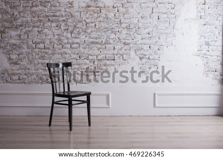 ROOM minimalism, chair in the room, the background STONE WALL, MODERN ROOM.  DECORATIVE BRICK WALL WHITE AND BLACK CHAIR CHAIR. Modern living room,  light background. Living room, brick wall, NEW ROOM -